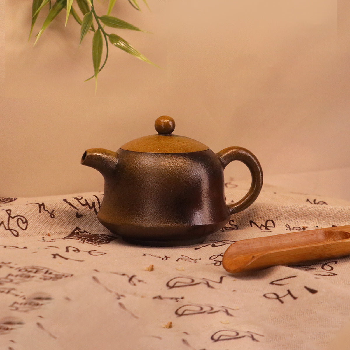 Handcerami artisan Rongchang Chinese pottery teapot in dark brown with round lid on decorated cloth