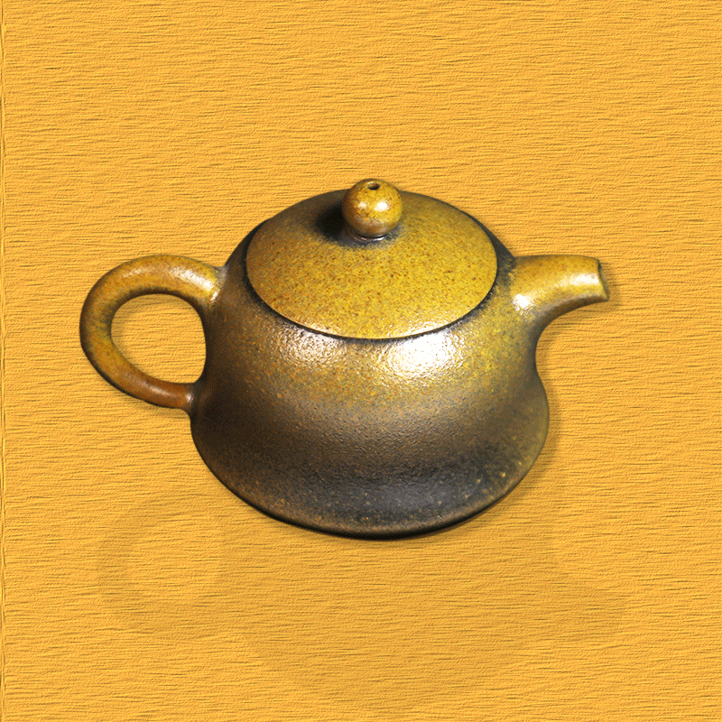 Handcrafted artisan Rongchang Chinese pottery teapot with smooth rounded shape and earthy yellow glaze