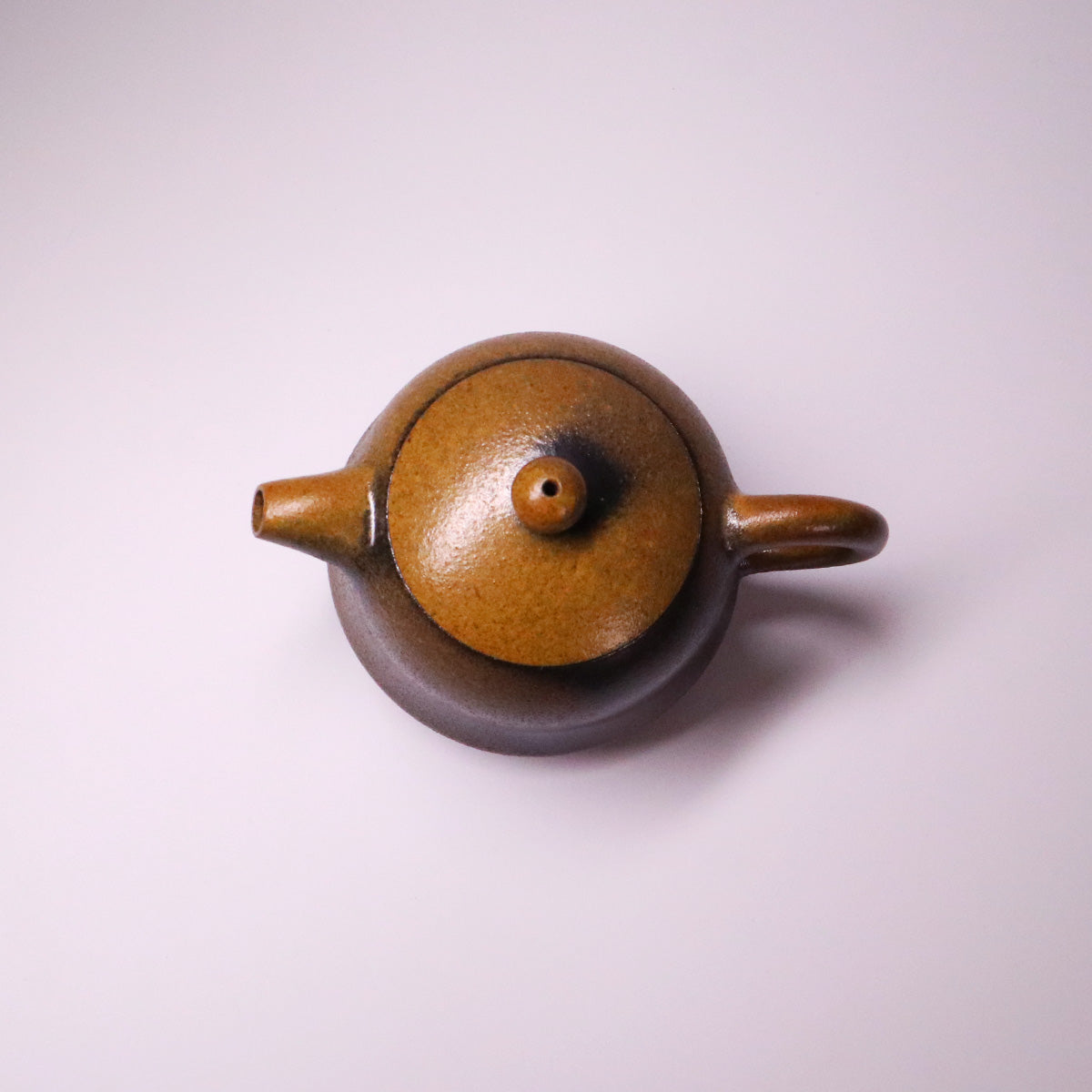 Handcrafted artisan Rongchang Chinese pottery teapot with a brown glaze and traditional design