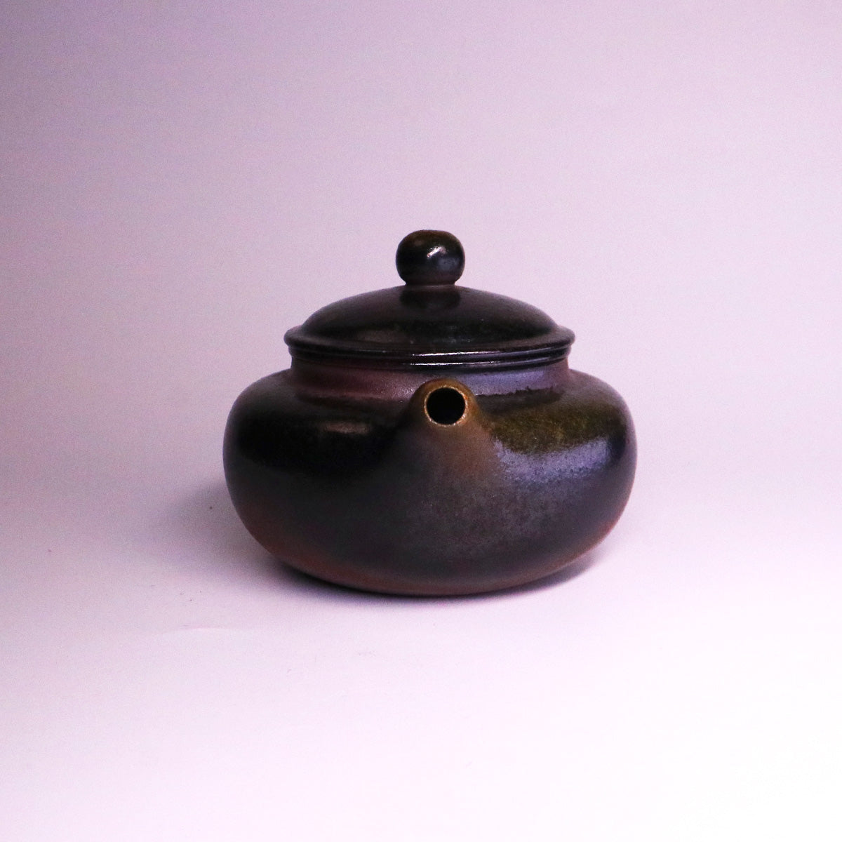 Chinese Handcrafted Fanggu Teapot made of pure handmade ceramics with a round dark glaze finish
