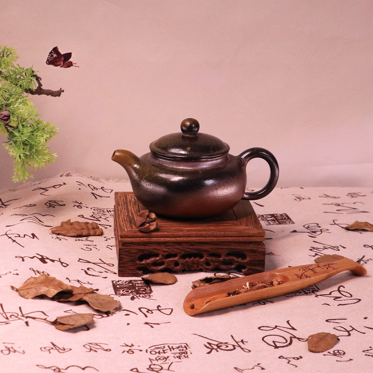 Chinese Handcrafted Fanggu Teapot made of pure handmade ceramics on a wooden stand with calligraphy background