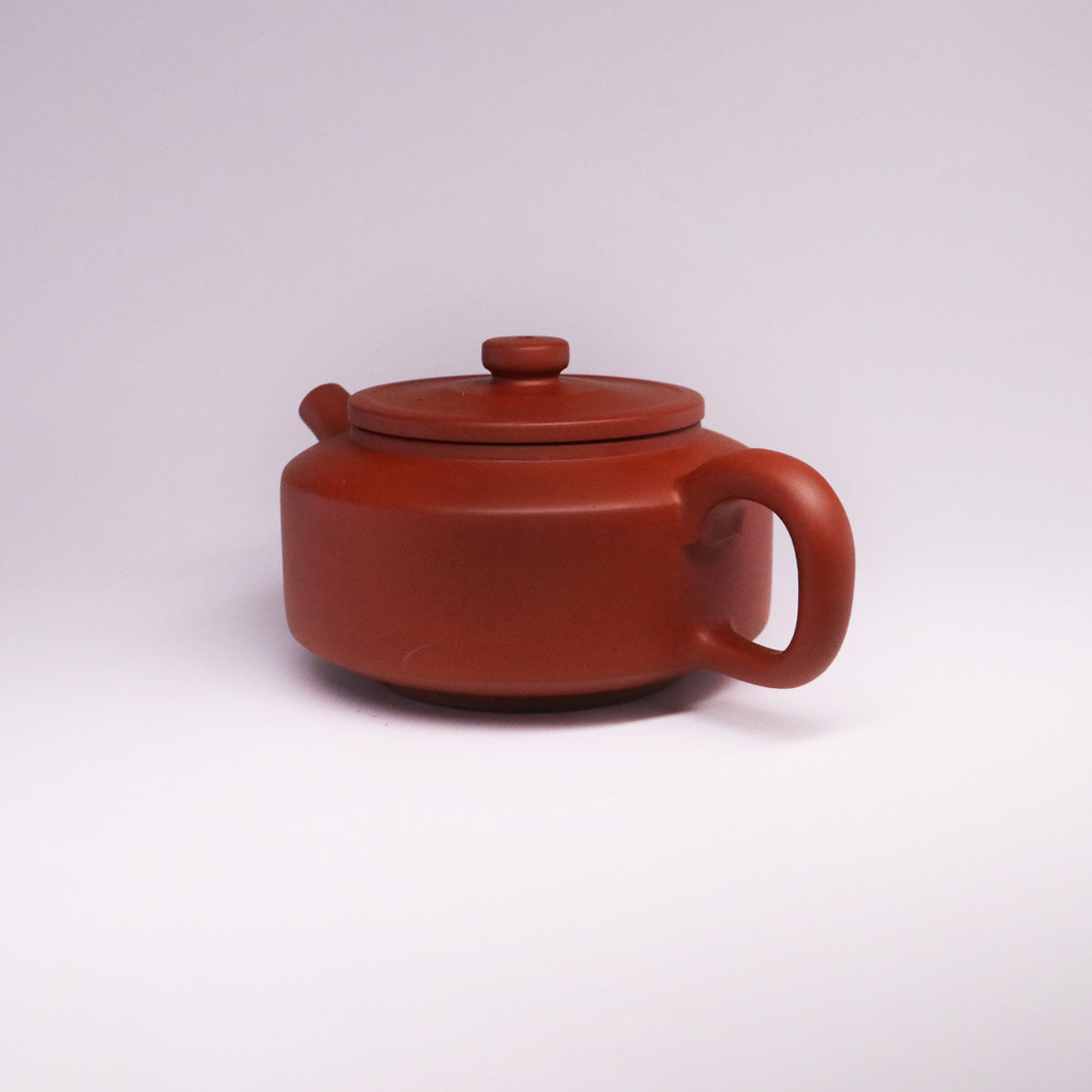 Chinese Rongchang handcrafted teapot made of pure handmade ceramics with a round lid and smooth handle