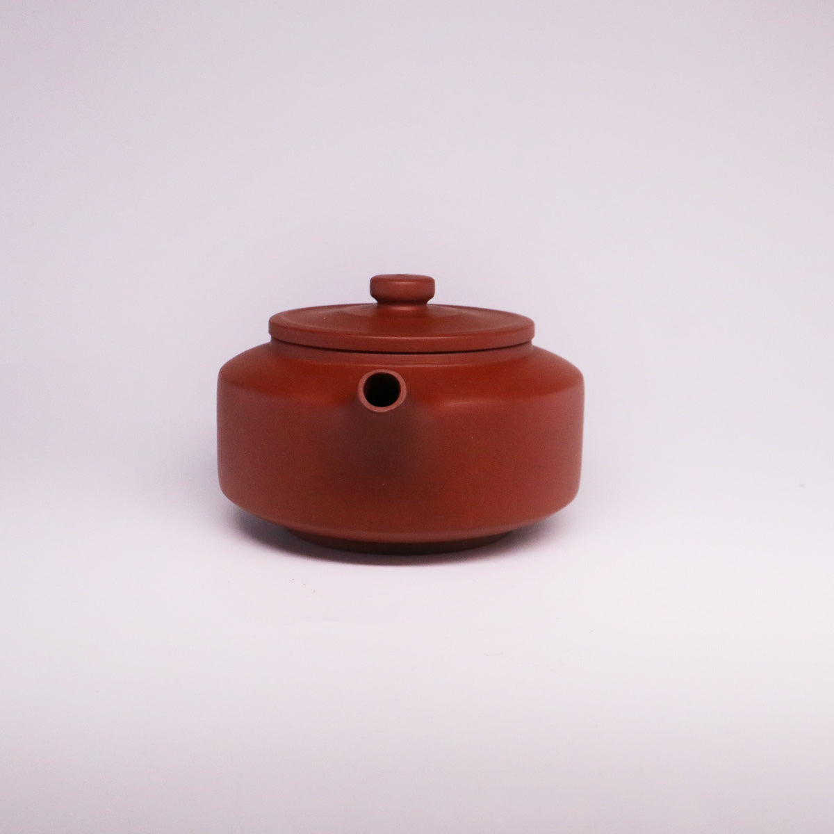 Chinese Rongchang handcrafted teapot in pure handmade ceramics with a rounded shape and Lid
