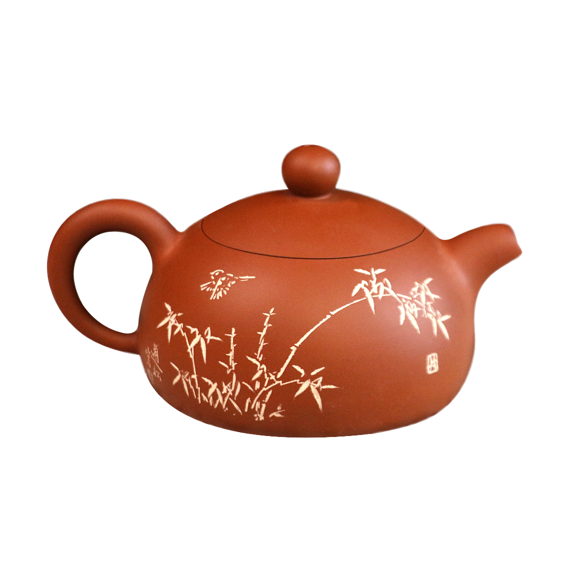 Handcrafted ceramic teapot in terracotta color with delicate bamboo and bird design