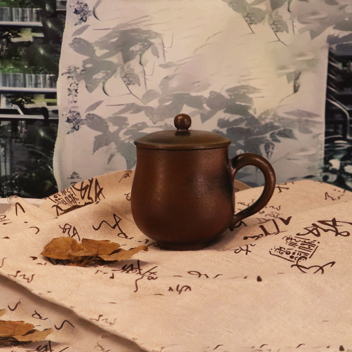 Handcerami Chinese Rongchang ceramics Belle Cup in dark brown with lid on fabric with calligraphy