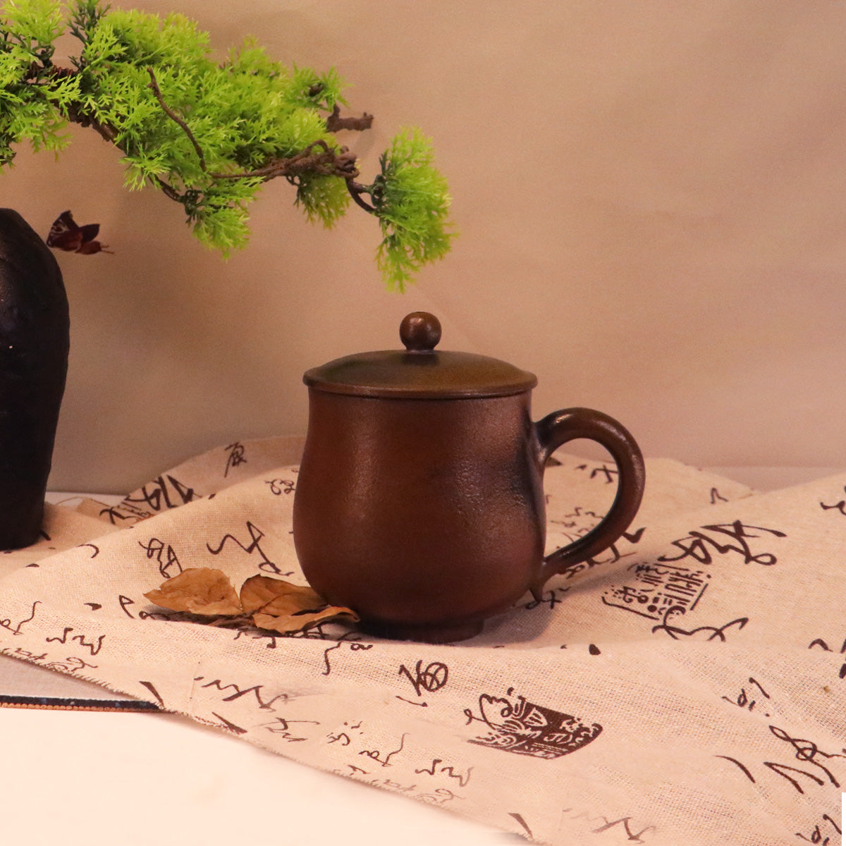 Chinese Rongchang ceramics Belle Cup in brown handmade ceramic with lid on printed fabric background